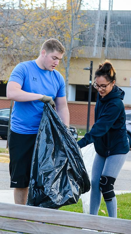 Students picking up garbage on campus
